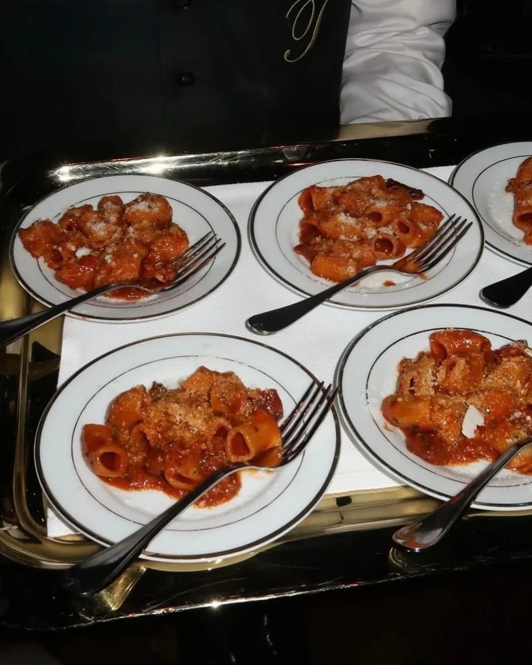 Plates of fresh pasta in tomato sauce ready to be served