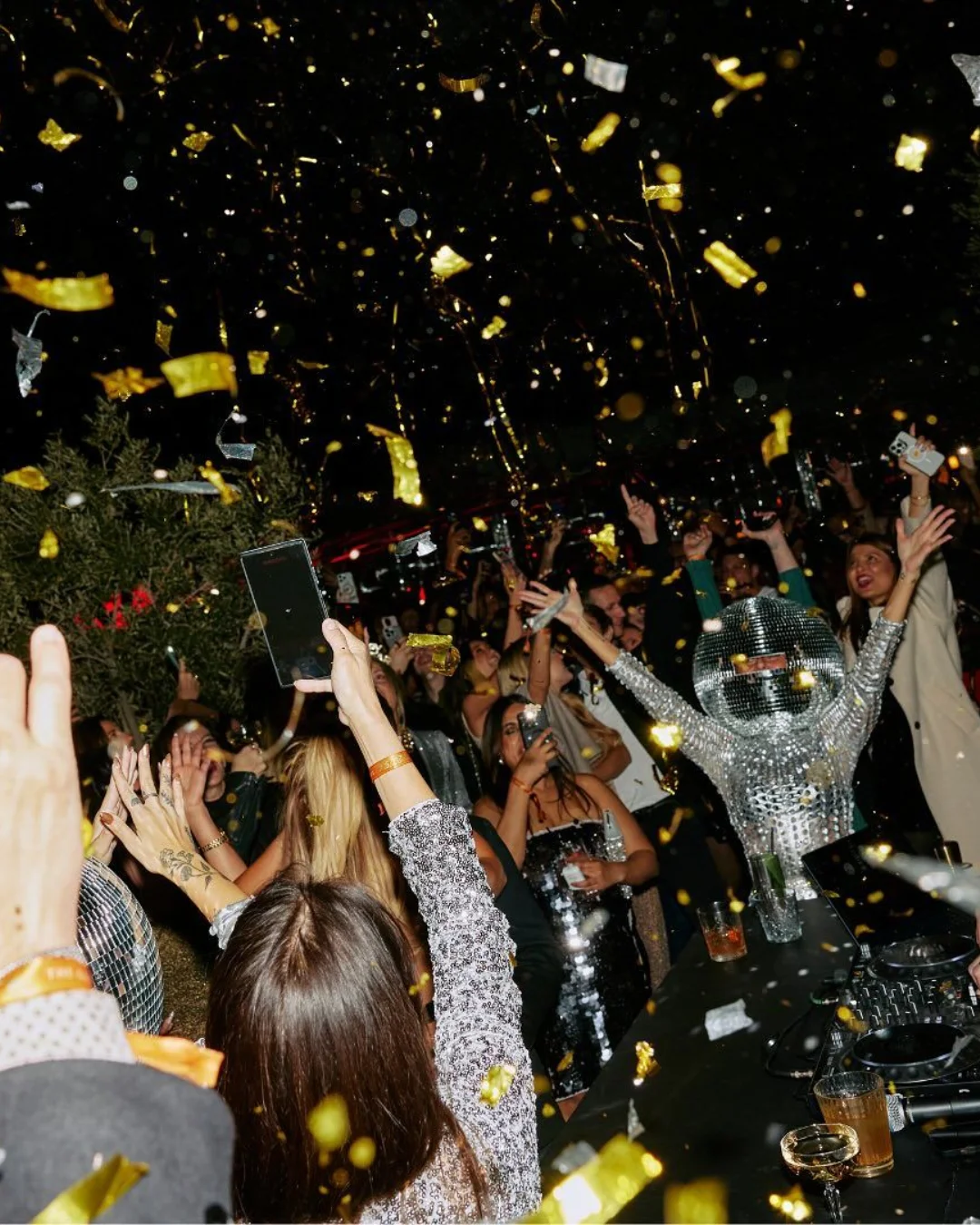 Guests dancing beneath golden confetti
